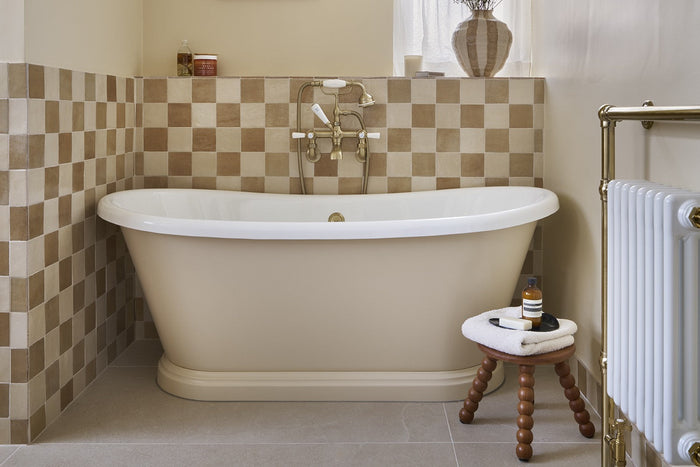 Rachael Keegan's bathroom with a freestanding bath against Journeyman Zellige Caramel and Beige chequerboard tiles and Porth Wen Beige floor tiles