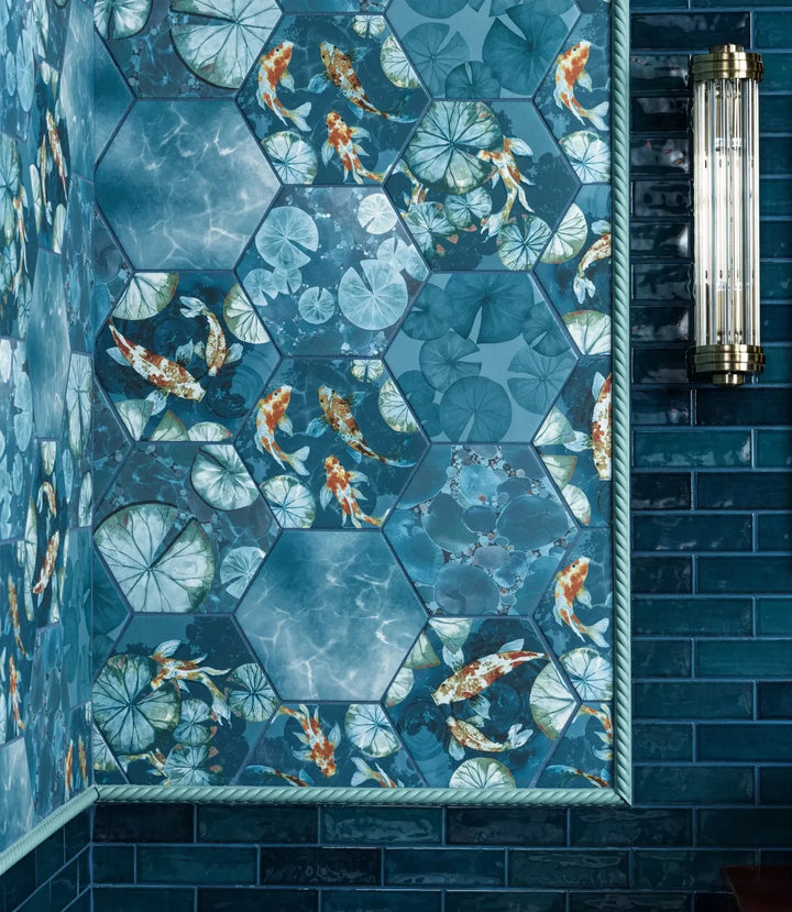 curated-little-bricks-gloss-blue-5cm-x-15cm | Hexagonal tiles with fish and lily pad design in a blue bathroom setting
