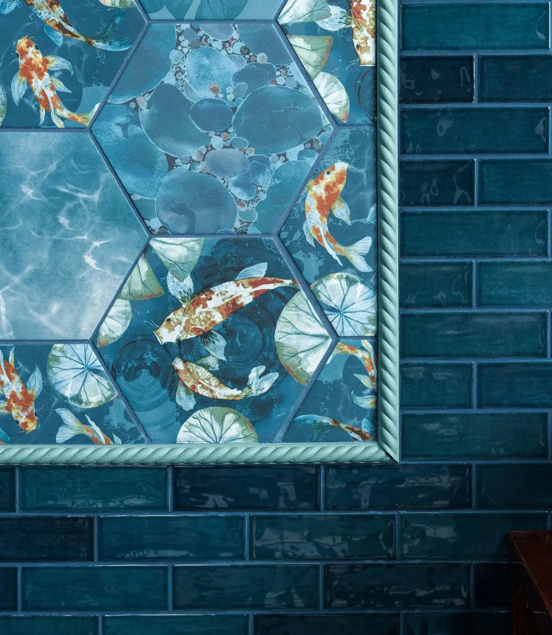 koi, curated-paintable-rope-trims-1-9cm-x-112cm | Decorative tile with koi fish pattern on a blue tiled wall.