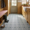 Solstice Green tiles on a boot room floor with ochre panelled cabinetry, Belfast sink, wellies and dog bowl