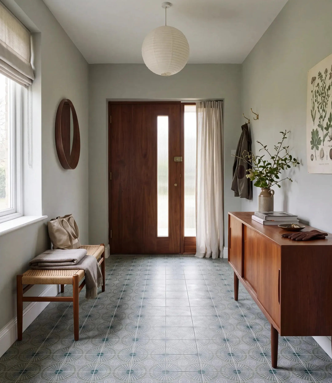 solstice green 20 x 20cm solstice green tiles in a calm entrance hall with walnut front door rush seat bench teak sideboard and paper pendant